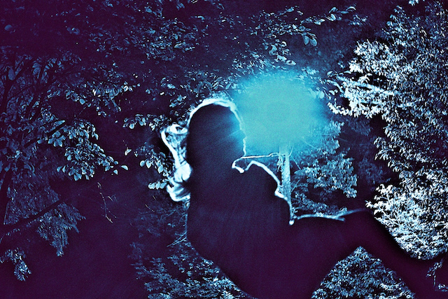 Girl on a swing at night.